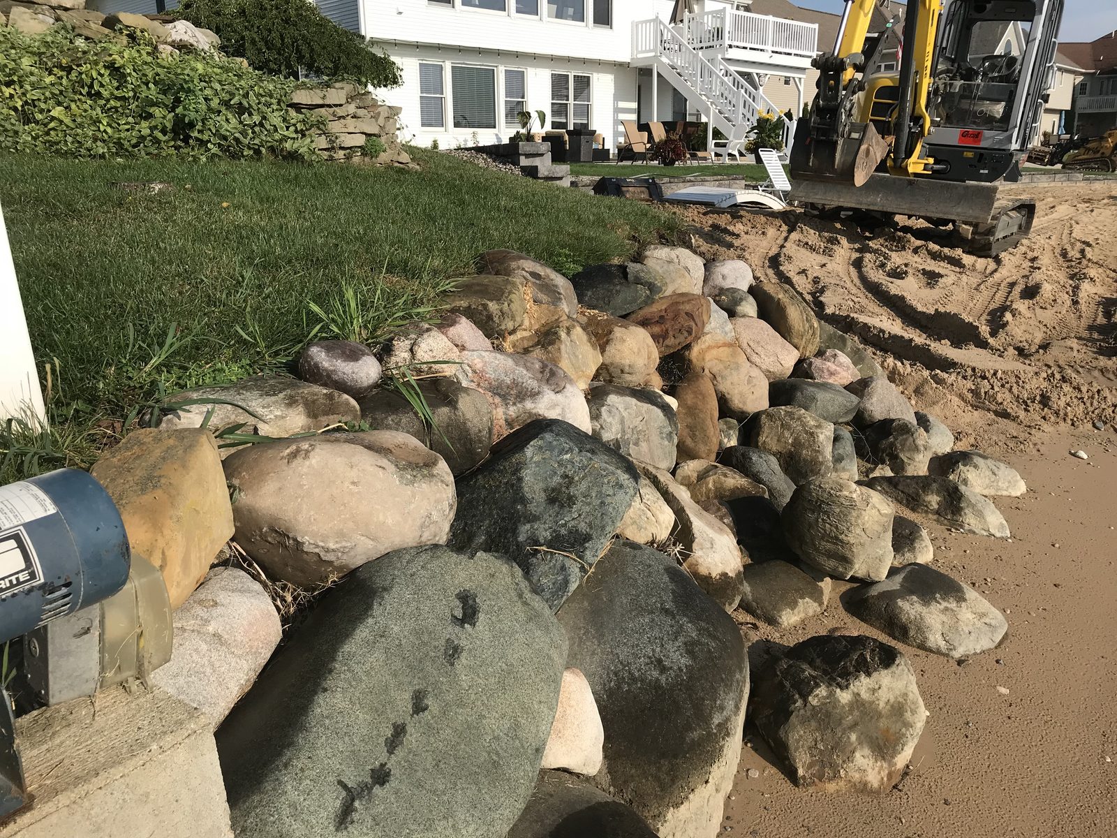 Boulder rip-rap seawall installation on a West Michigan lakefront property